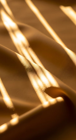 golden satin background with some smooth lines in it (shallow DOF)の写真素材
