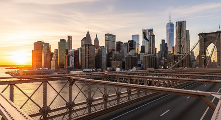 Panoramic view of Brooklyn Bridge and Manhattan skyline at sunset.の写真素材