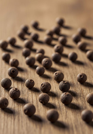 Pile of allspice on wooden table. Selective focus.の写真素材