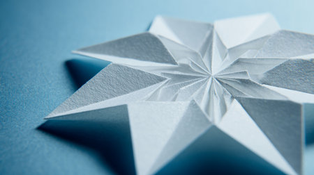 Paper origami star on blue background. Minimalistic concept.