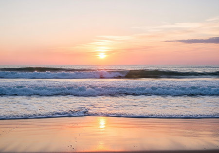 Beautiful sunset on the beach with waves and clouds in the skyの写真素材