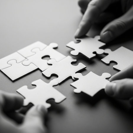 Hands of business people assembling jigsaw puzzle, black and white toneの写真素材