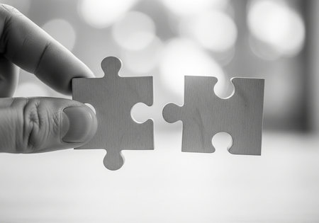 Hand connecting jigsaw puzzle pieces, black and white tone, business conceptの写真素材