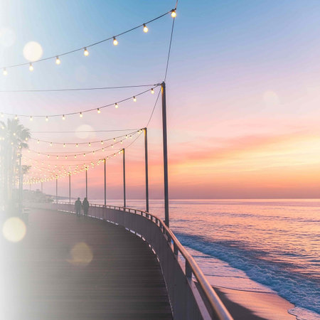 Wooden pier on the seashore at sunset with lights.の写真素材