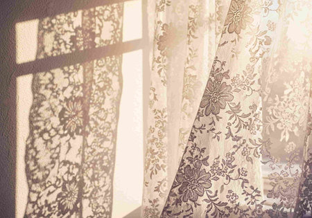 Curtains with floral pattern in sunlight. Vintage style toned pictureの写真素材
