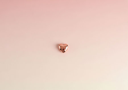 Gold heart on a pink background. Love concept.