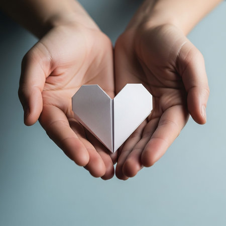 Paper heart in female hands, valentine's day concept.の写真素材