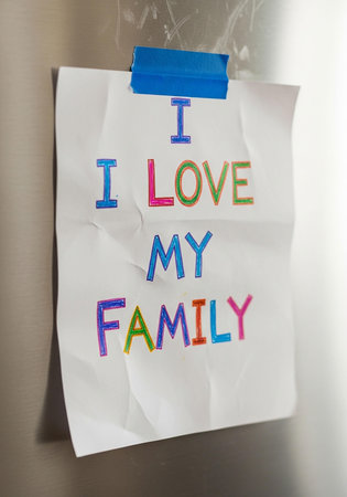 I love my family written on a paper attached to a fridge doorの写真素材