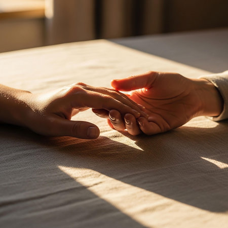 Close up of man and woman holding hands while sitting at table in cafeの写真素材