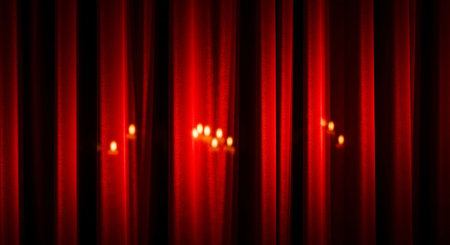 Red stage curtain with spotlights. Cinema or theater curtain background.の写真素材