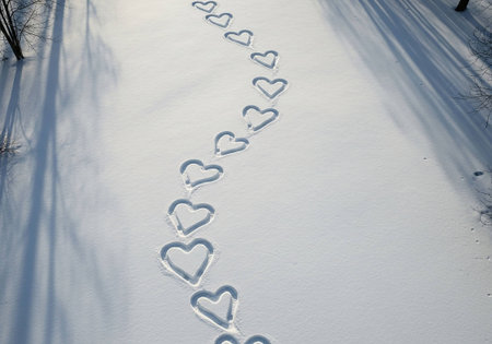Heart-shaped trail in the snow in the forest, winter landscapeの写真素材