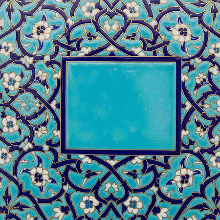 Vintage blue ceramic tile with floral ornament. Close-up.