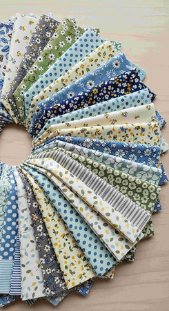 Colorful patchwork fabric swatches on wooden background. Handmade.