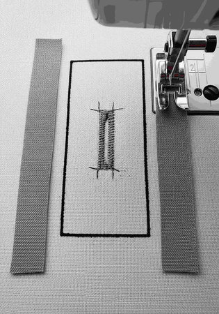 Sewing machine and thread on fabric.