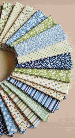 Fabric samples in a basket on wooden background. Top view.