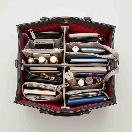 Top view of an open leather briefcase full of stationery.の写真素材