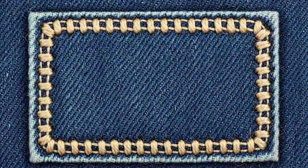 Denim background with stitches and copy space. Jeans texture.