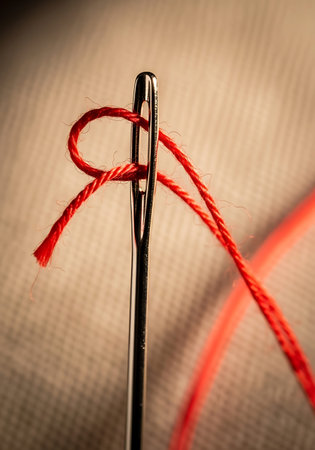 Needle and thread on a brown background. Shallow depth of fieldの写真素材