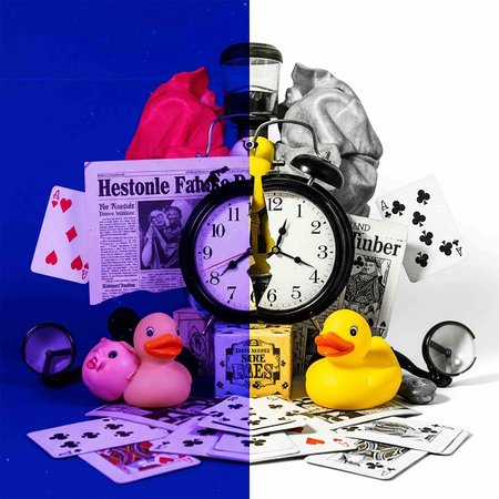 Alarm clock, money, dice and duck on a blue background