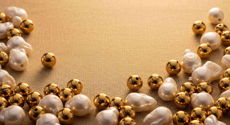 jewelry background with gold and white pearls on sackclothの写真素材