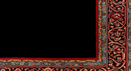 The texture of the fabric is dark red with a pattern on a black backgroundの写真素材