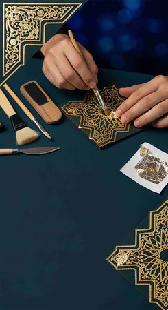 Hands of a jeweler making a golden ring on a black backgroundの写真素材