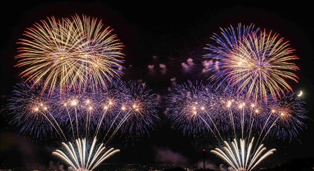 Colorful fireworks of various colors over night sky background, celebration conceptの写真素材