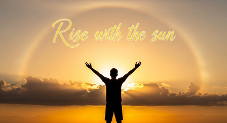 Man with hands up on the background of the sun and the inscription: Rise and Shineの写真素材