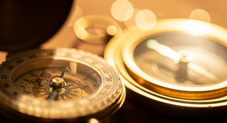 Compass and magnifying glass with bokeh light background.の写真素材