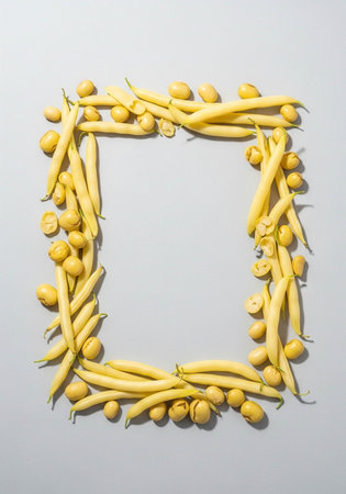 Yellow beans frame on white background. Flat lay, top view.の写真素材