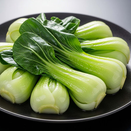 Bok choy (chinese cabbage) on a black plateの写真素材