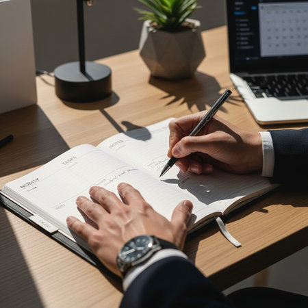 cropped shot of businessman writing in notepad at workplace in officeの写真素材