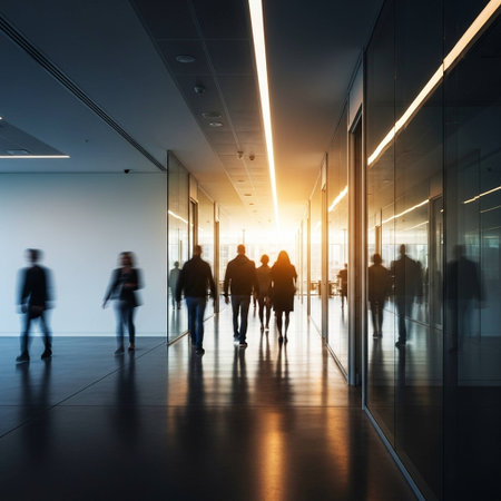 Silhouettes of business people walking in corridor of modern office buildingの写真素材