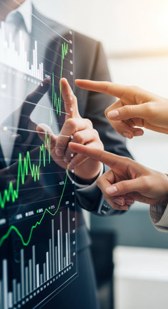 business, technology and people concept - close up of businessman and businesswoman pointing finger to virtual screen with forex chartの写真素材