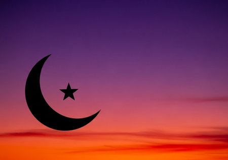Silhouette of crescent and star on sunset sky background.の写真素材