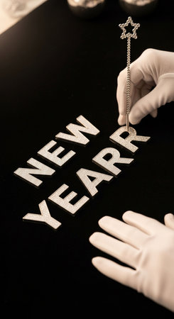 Hands in white gloves with a star and the word new yearの写真素材