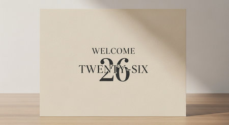 welcome twenty six text on beige paper on wood tableの写真素材