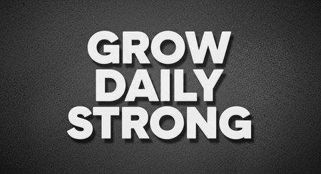 Grow Daily Strong text on black textured wall backgroundの写真素材