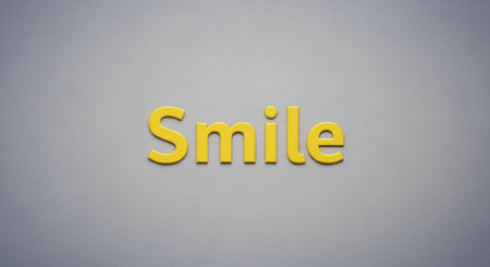 Word smile made of yellow wooden letters on a gray background.の写真素材