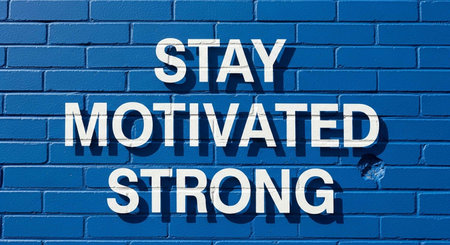 Stay Motivated Staying Strong Concept on Blue Brick Wall with Copy Spaceの写真素材