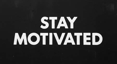 Stay Motivated sign on a black wall. Motivational conceptの写真素材