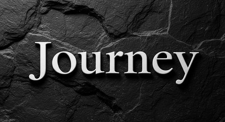 Journey word on black stone background. Black stone background with white letters.の写真素材