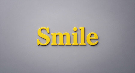 Word Smile made of yellow plastic letters on a gray background. Business concept.の写真素材