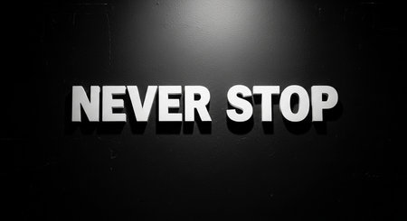 Never stop sign text on black wallの写真素材