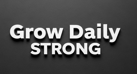 The inscription "Grow Daily Strong" on a black background.の写真素材