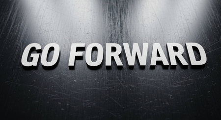 The word Go forward written in white letters on a dark background.の写真素材