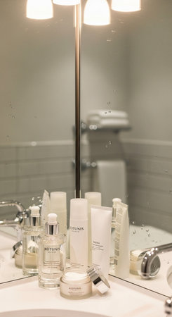 Luxury cosmetic products on a vanity table in a modern bathroomの写真素材
