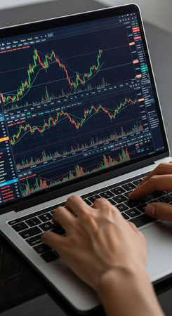Close-up of businesswoman hands typing on laptop keyboard with forex chart