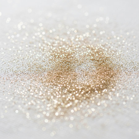 Golden glitter texture on white fabric background. Close-up image.の写真素材