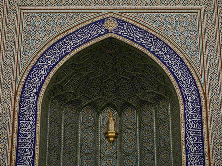 Detail of an ornate archway with intricate tile work and calligraphy.の写真素材